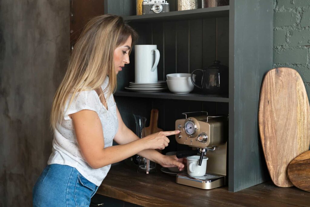 blondina doma obsluhuje automatický kávovar
